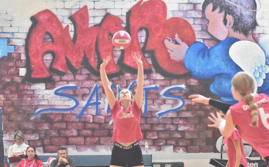 Aviano’s Mayci Salmon almost appears to have divine assistance while setting the ball Saturday, Oct. 14, 2023, against Rota. But the Admirals prevailed in five sets.