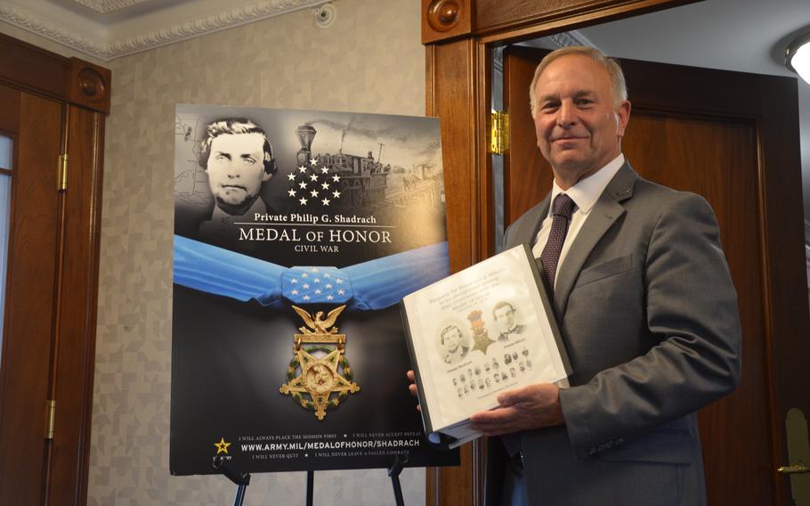 Ron Shadrach, a great cousin of Pvt. Philip Shadrach, standing next to a poster of his relative July 2, 2024. Philip and Pvt. George Wilson, Union soldiers during the Civil War, will receive the Medal of Honor on July 3, 2024.