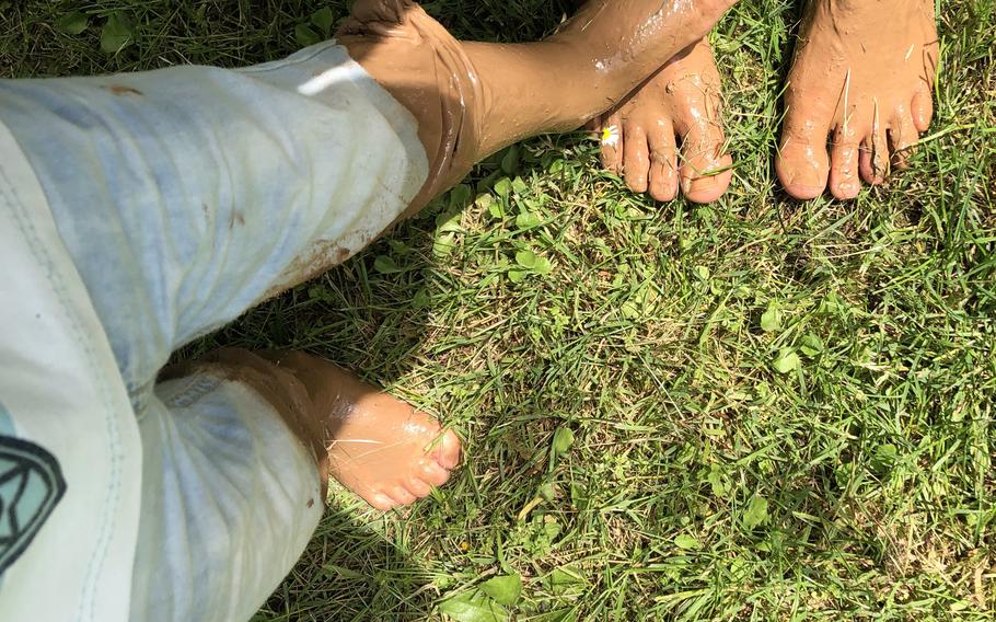 Hikers show off their feet after crossing the mud basin at the barefoot park in Bad Sobernheim, Germany.