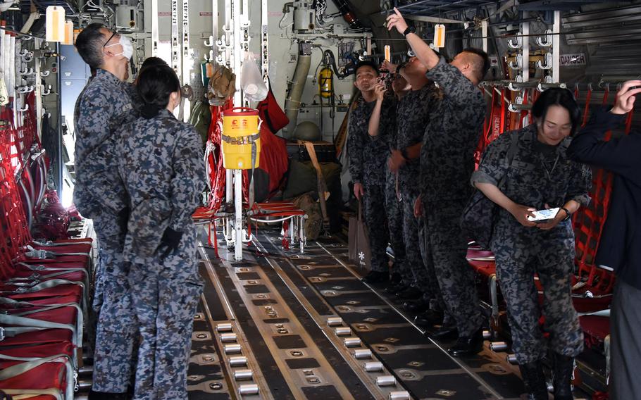 Japanese airmen check out an Air Force C-130J Super Hercules ahead of their orientation flight out of Yokota Air Base in western Tokyo, May 26, 2023. 
