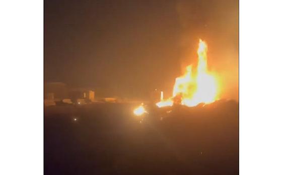 A video screen grab shows flames shooting upwards after an explosion that struck a base belonging to the Popular Mobilization Forces, a coalition of Iran-allied militias, overnight.