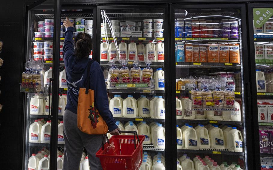 A shopper reaches for cottage cheese inside a grocery store in San Francisco in May 2022. Half of Americans say they are financially worse off now than they were a year ago, the highest share since 2009, according to a Gallup poll released Wednesday.