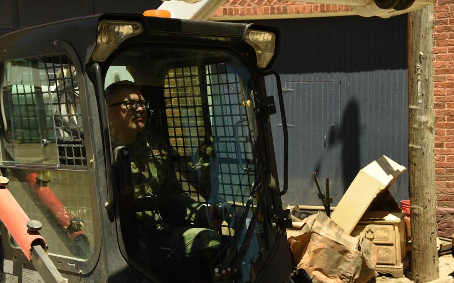 U.S. Air National Guard Staff. Sgt. Derrick Colyer dumps debris in a dump truck in Sioux Rapids, Iowa, June 30, 2024. 