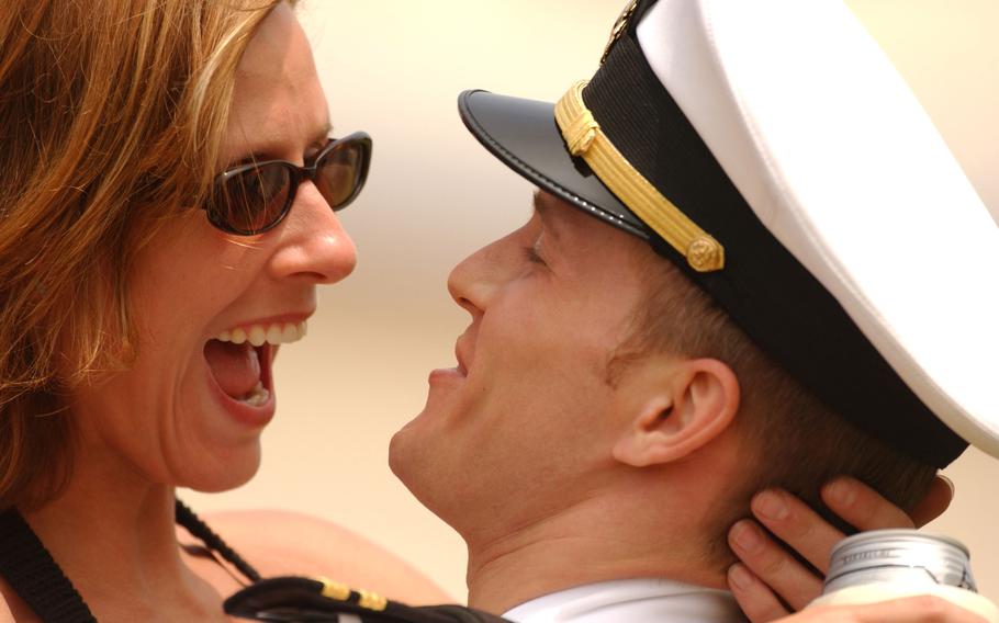 Lt. Clark Hickingbottom hugs his wife Charlotte at Atsugi Naval Air Facility, Japan, after returning from a four-month deployment. Hickingbottom was deployed aboard USS Kitty Hawk with Helicopter Antisubmarine Squadron One Four in support of Operation Iraqi Freedom.