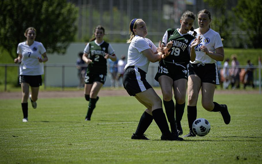 Blanca Diaz Hernandez of AFNORTH is squeezed between Brussels defenders Emilia Day, left, and Taegan Muller during the 2024 DODEA European Soccer Division III Championships in Landstuhl, Germany, on May 20, 2024.