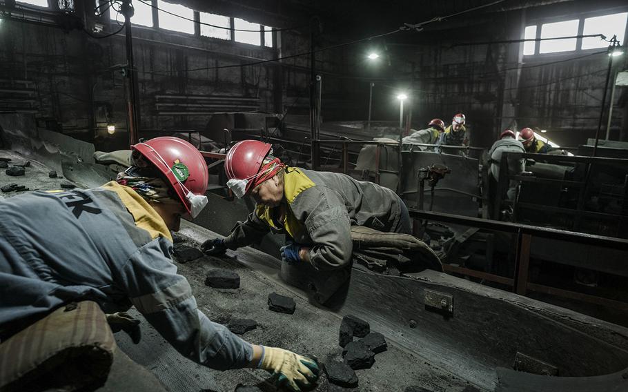 Workers sort coal in a mine in Ukraine’s eastern Donbas region, not far from the war’s front line. 