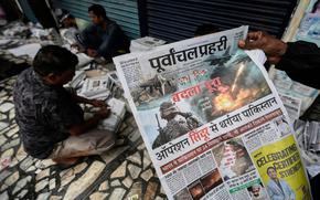 Vendors sort newspapers for distribution.