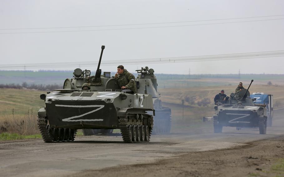 Russian military vehicles move on a highway in an area controlled by Russian-backed separatist forces near Mariupol, Ukraine, Monday, April 18, 2022. Mariupol, a strategic port on the Sea of Azov, has been besieged by Russian troops and forces from self-proclaimed separatist areas in eastern Ukraine for more than six weeks.