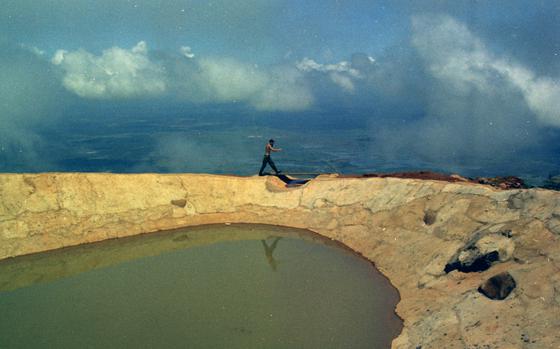 Black Virgin Mountain, South Vietnam, Oct. 14, 1969: A soldier walks on the outer edge of "Black's Bathtub," atop Nui Ba Den (Black Virgin) mountain as clouds roll by behind him at the outpost at an elevation of 3,200 feet. The camp's rain-catch basin supplies all but the drinking water for the outpost.

Read the article on the high elevated outpost and see more photos here.
https://www.stripes.com/news/black-virgin-mountain-nice-place-to-visit-1.296219


Looking for Stars and Stripes’ coverage of the Vietnam War? Subscribe to Stars and Stripes’ historic newspaper archive! We have digitized our 1948-1999 European and Pacific editions, as well as several of our WWII editions and made them available online through https://starsandstripes.newspaperarchive.com/

META TAGS: Pacific; South Vietnam; Vietnam War; mountain; summit; outpost; camp; base; U.S. Army; servicemember; clouds; military life; landscape