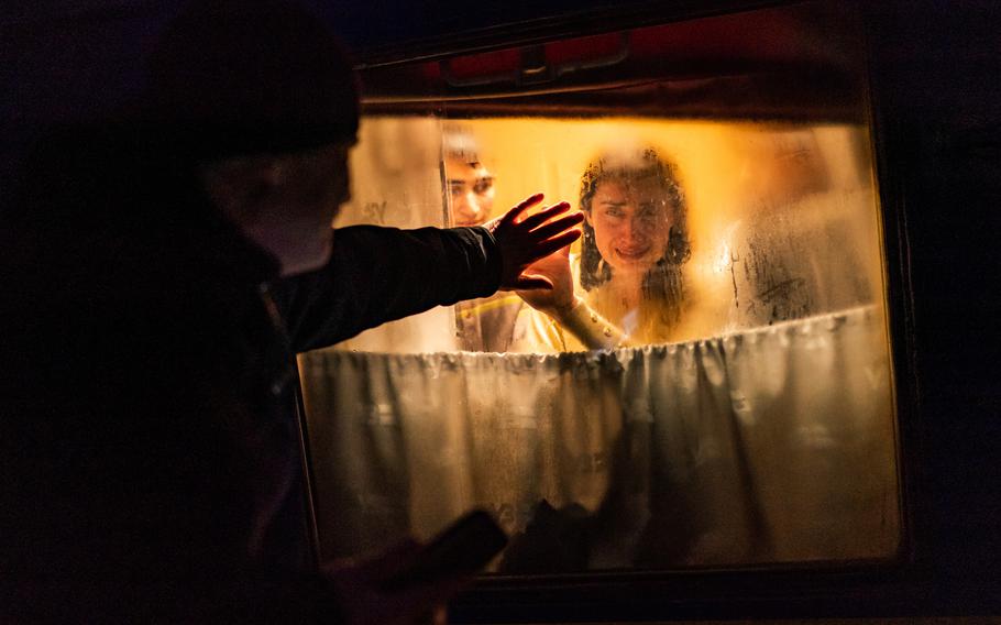 George Keburia says goodbye to his children and his wife, Maya, after they boarded a train to Lviv at a station in Odessa on March 5. Hundreds were trying to leave before the violence of war reached the city.