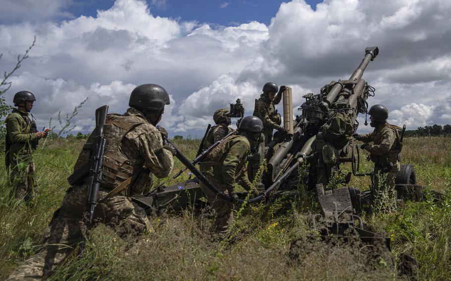 Ukrainian servicemen prepare to fire at Russian positions from a U.S.-supplied M777 howitzer in Kharkiv region, Ukraine, July 14, 2022. 