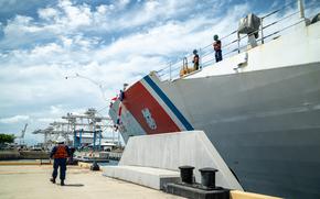 U.S. Coast Guardsmen assigned to the maritime security cutter USCGC Kimball (WMSL 756) throw a heaving line to the pier on Coast Guard Base Honolulu May 5, 2025. While at sea, Kimball's crew countered transnational criminal organizations and prevented dangerous illegal narcotics from reaching the United States. (U.S. Coast Guard photo by Petty Officer 2nd Class Tyler Robertson)