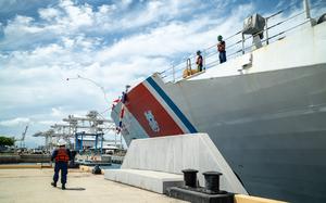 U.S. Coast Guardsmen assigned to the maritime security cutter USCGC Kimball (WMSL 756) throw a heaving line to the pier on Coast Guard Base Honolulu May 5, 2025. While at sea, Kimball's crew countered transnational criminal organizations and prevented dangerous illegal narcotics from reaching the United States. (U.S. Coast Guard photo by Petty Officer 2nd Class Tyler Robertson)