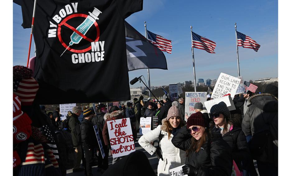 People gather at the Washington Monument before proceeding to the Lincoln Memorial for the "Defeat the Mandates: An American Homecoming" rally on Sunday, Jan. 23, 2022 in Washington, D.C. Protesters were voicing their disagreement with vaccine mandates.