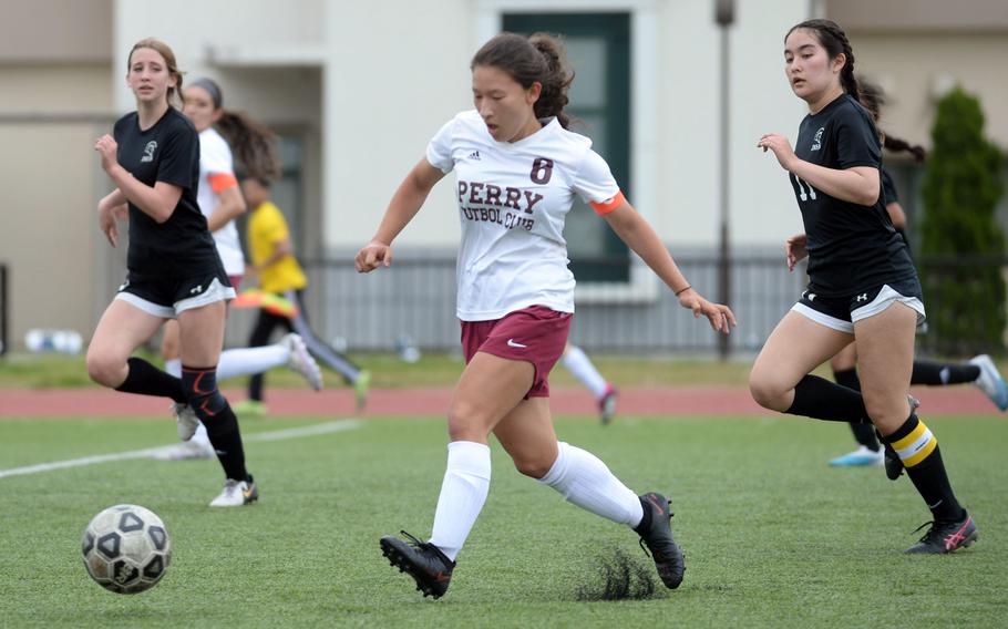 Matthew C. Perry's Sasha Malone boots the ball upfield between Zama American's Lainey Felt and Lindsey So during Saturday's DODEA-Japan girls soccer match. The Samurai won 4-1.