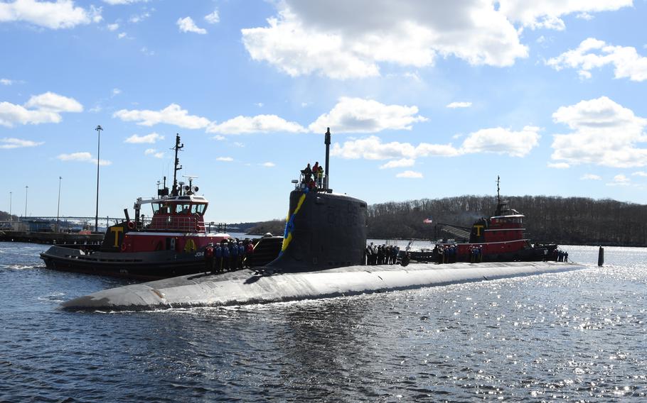 The USS Indiana alongside a support boat.
