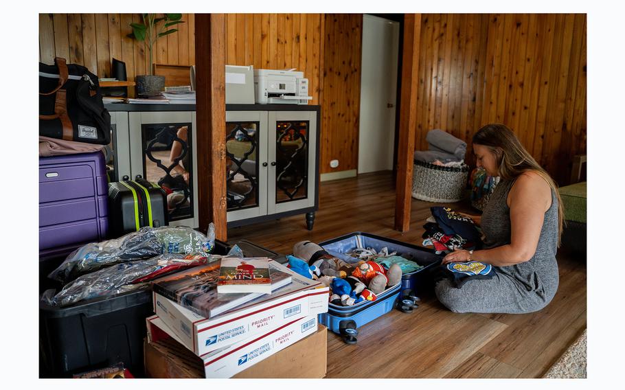 Amy Chadwick packs her son's T-shirts and toys at her temporary home in Lahaina. Chadwick and her family of five with three dogs are moving to Florida at the end of December after losing their home in August's wildfire. 