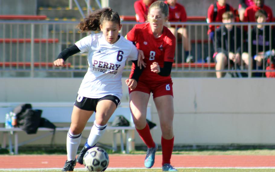 Matthew C. Perry’s Sasha Malone and Nile C. Kinnick’s Bree Withers scrum for the ball during Saturday’s DODEA-Japan girls soccer match. The Red Devils won 5-0.