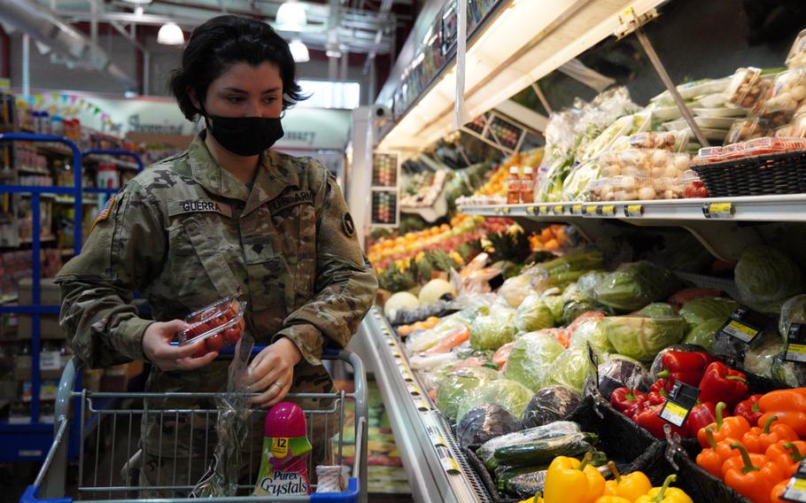 Army Spc. Victoria Guerra wears a mask while shopping at the commissary on Camp Zama, Japan, Thursday, Feb. 3, 2022. 