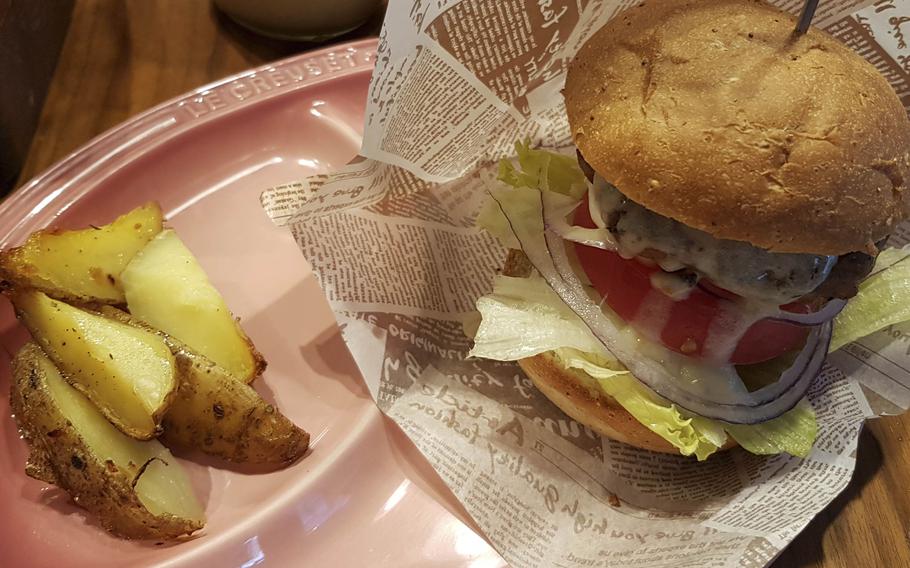 The soy-based Truffle Cheese vegan burger and a side of potato wedges from Mr. Farmer, a plant-based eatery with locations throughout Tokyo and Yokohama, Japan.