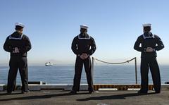 Sailors man the rails on the flight deck of the aircraft carrier USS Nimitz in San Diego, Feb. 26, 2021.