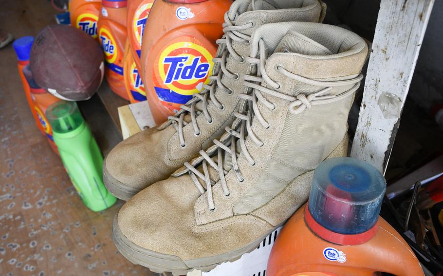 Boots like those issued by the U.S. military and a football are displayed prominently at a shop outside Bagram Airfield, Afghanistan, June 5, 2021. None of the shopkeepers said they knew what the American football was for. 