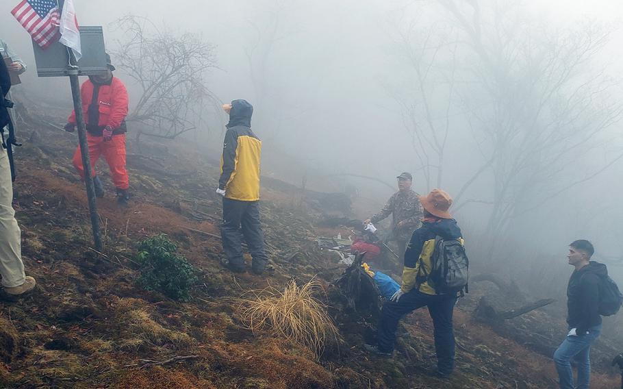 A group of U.S. military officers partnered with Japanese hikers in southeastern Japan, March 26, 2023, to recover parts of a B-29 Superfortress that crashed in the waning days of World War II.