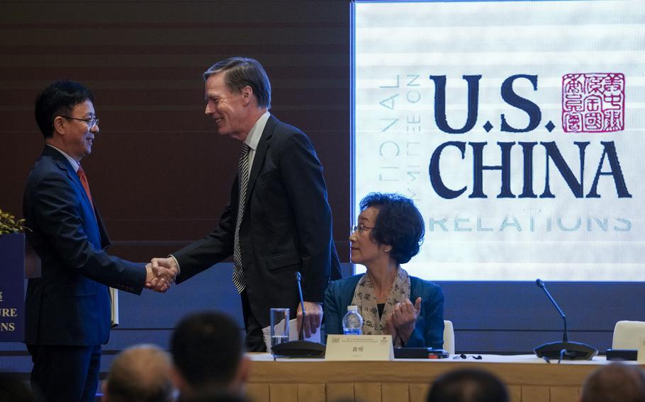U.S. Ambassador to China Nicholas Burns, center, shakes hands with Wu Xinbo, Professor & Dean, Institute of International Studies at Fudan University during the Barnett-Oksenberg Lecture on Sino-American Relations hosted by Amcham Shanghai, at a hotel in Shanghai, China, Wednesday, June 26, 2024. At right is Yuan Ming, Professor, School of International Studies, Peking University.