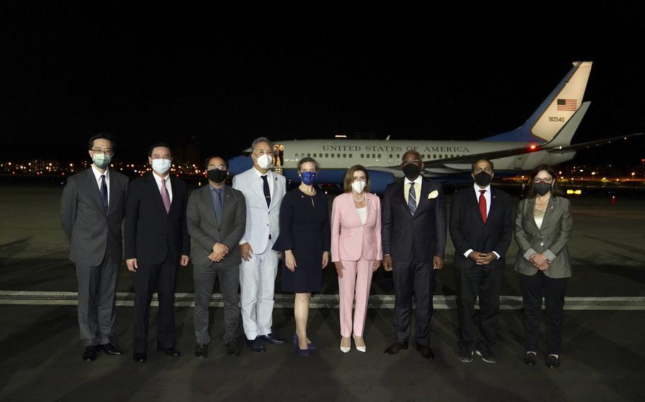 In this photo released by the Taiwan Ministry of Foreign Affairs, U.S. House Speaker Nancy Pelosi, center pose for photos after she arrives in Taipei, Taiwan, Tuesday, Aug. 2, 2022. Pelosi arrived in Taiwan on Tuesday night despite threats from Beijing of serious consequences, becoming the highest-ranking American official to visit the self-ruled island claimed by China in 25 years. 