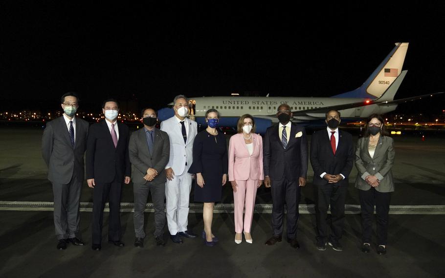 In this photo released by the Taiwan Ministry of Foreign Affairs, U.S. House Speaker Nancy Pelosi, center pose for photos after she arrives in Taipei, Taiwan, Tuesday, Aug. 2, 2022. Pelosi arrived in Taiwan on Tuesday night despite threats from Beijing of serious consequences, becoming the highest-ranking American official to visit the self-ruled island claimed by China in 25 years.