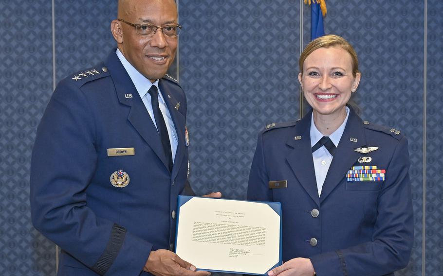 Capt. Taylor Bye poses with Air Force Chief of Staff Gen. CQ Brown Jr. at the Pentagon, Arlington, Va., May 11, 2022. Bye was awarded the 2020 Koren Kolligian Jr. Trophy to recognize her outstanding airmanship when her A-10C attack aircraft suffered a catastrophic gun malfunction. She performed a belly landing with the loss of the landing gear and canopy. 