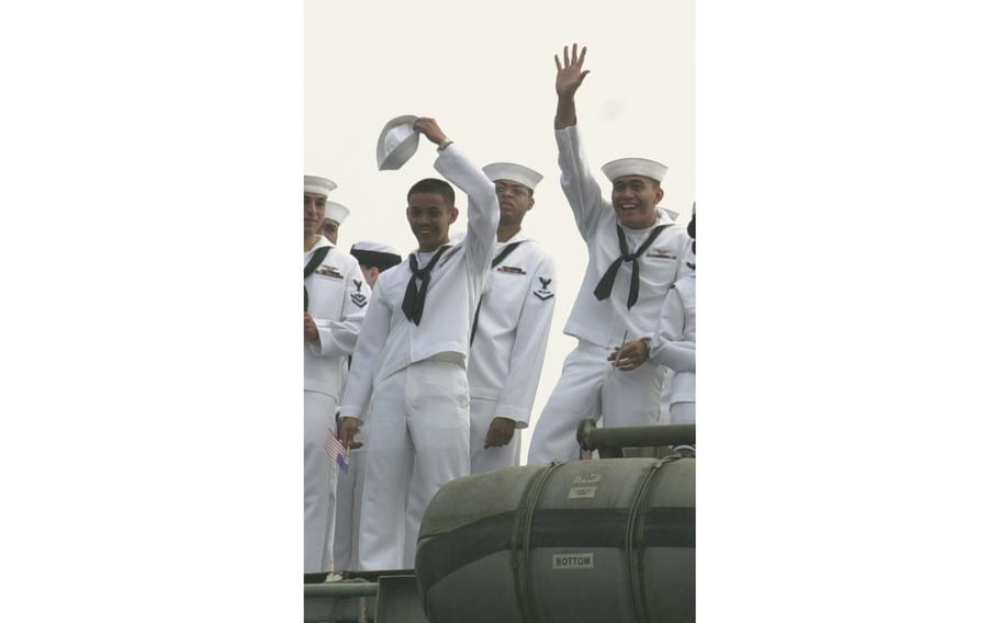 Sailors wave to friends and family on the pier in Yokosuka as the USS Kitty Hawk returns home from Operation Iraqi Freedom.