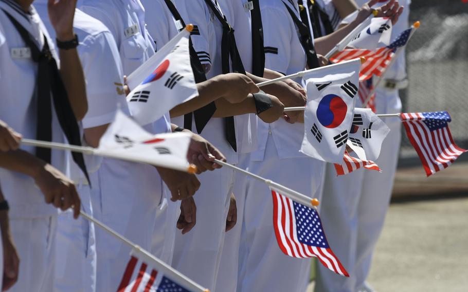 South Korean sailors welcome the aircraft carrier USS Ronald Reagan to Busan, South Korea, Friday, Sept. 23, 2022.