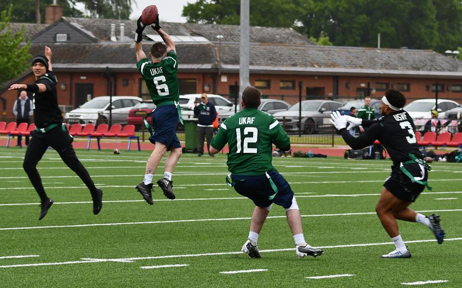A United Kingdom air forces service member jumps and catches the football during a multi-service flag football game sponsored by the New York Jets at RAF Lakenheath on Friday.