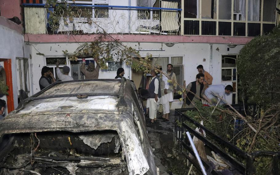 Afghans inspect damage of Ahmadi family house after U.S. drone strike, Aug. 29, 2021, in Kabul, Afghanistan. The Afghan survivors of the U.S. drone strike that killed 10 members of their family, including seven children, said in December that they are frustrated and saddened by a decision that no U.S. troops involved in the strike will face disciplinary action. 