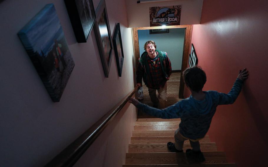 Tim McLaughlin’s son Roland, 8, makes his way downstairs. McLaughlin hopes to shape his two sons’ understanding of his role in Iraq and its profound effect on him. 