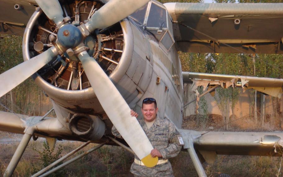 Then-Air Force Tech Sgt. Gino Lucci stands by a prop plane at Manas Air Base in Kyrgyzstan in 2010. Lucci, who deployed around the world during his 25 years in the service, retired in 2015. Four years later, he turned a World War II-era plane into a roadworthy motor home.