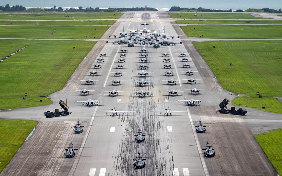 Aircraft line up on a runway at Kadena Air Base.