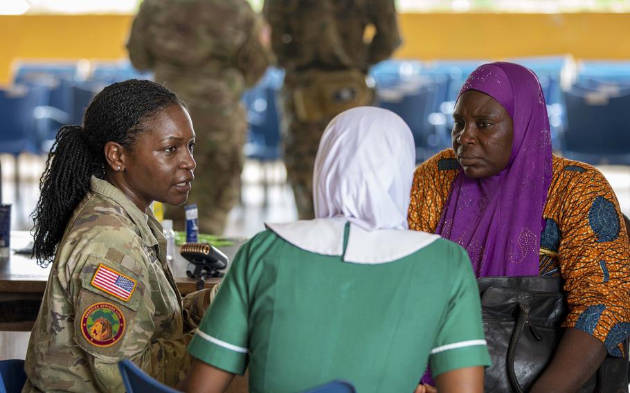 Army Maj. Amber Morton-Chism, a public health nurse with U.S. Army Health Center Vicenza, Italy, consults with a translator as part of exercise African Lion in Damongo, Ghana.