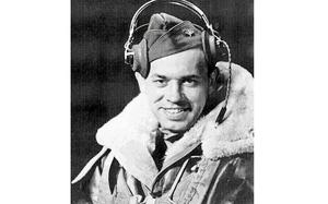 Rauh in his flight jacket with headphones on.