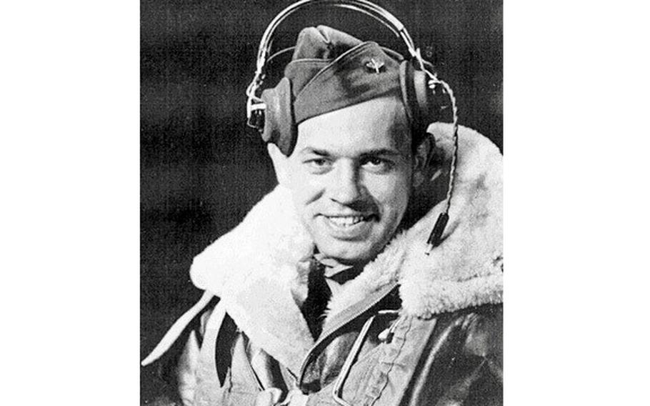 Rauh in his flight jacket with headphones on.