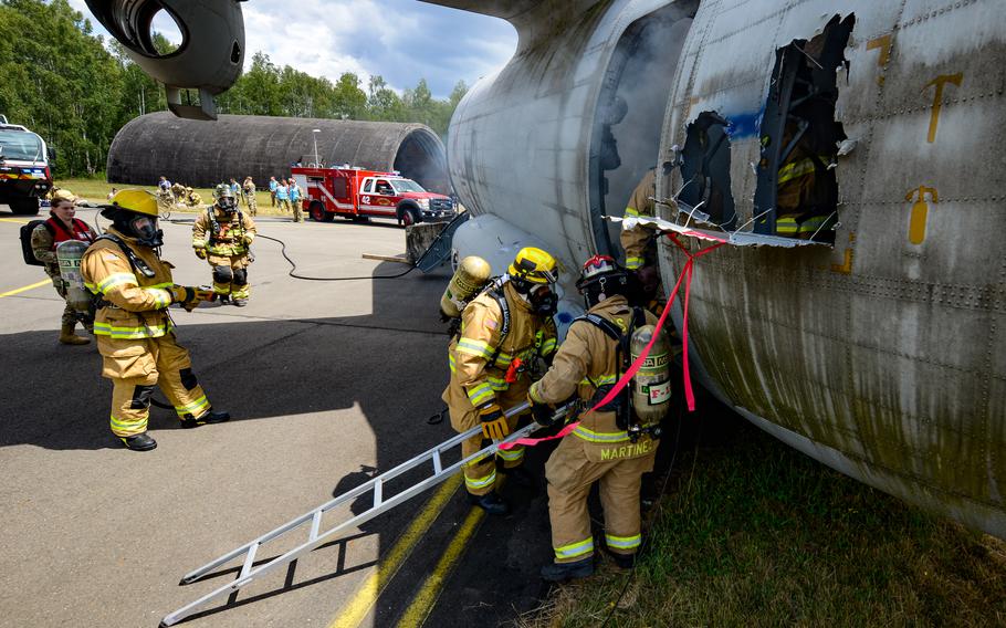 Firefighters assigned to the 86th Civil Engineer Group enter a training aircraft during Operation Varsity, an emergency response exercise at Ramstein Air Base, Germany, July 26, 2022. 