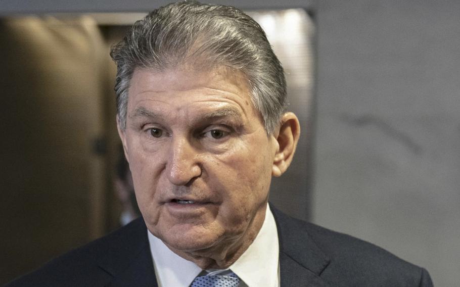 Sen. Joe Manchin, D-W.V., speaks to members of the media outside of his office on Capitol Hill in Washington on Dec. 13, 2021. MUST CREDIT: Bloomberg photo by Sarah Silbiger