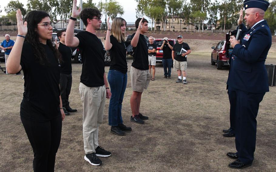 U.S. Space Force recruits recite the Oath of Enlistment to Maj. Mark Lazane, 362nd Recruiting Command Squadron recruiting operations director, during a total force enlistment ceremony at the Astronomy Association of Arizona Lunar Eclipse event May 15, 2022, in Buckeye, Ariz.