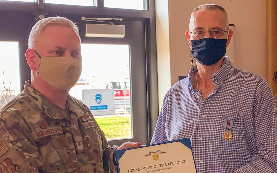 Col. Carl Magnusson, 914th Air Refueling Wing commander, presents Randy Wilson, 914th Security Forces chief of plans and programs, the Air Force Civilian Award for Valor on April 27, 2021, at the Niagara Falls Air Reserve Station, N.Y. The medal was awarded for heroic action in saving a man’s life in 2018. 