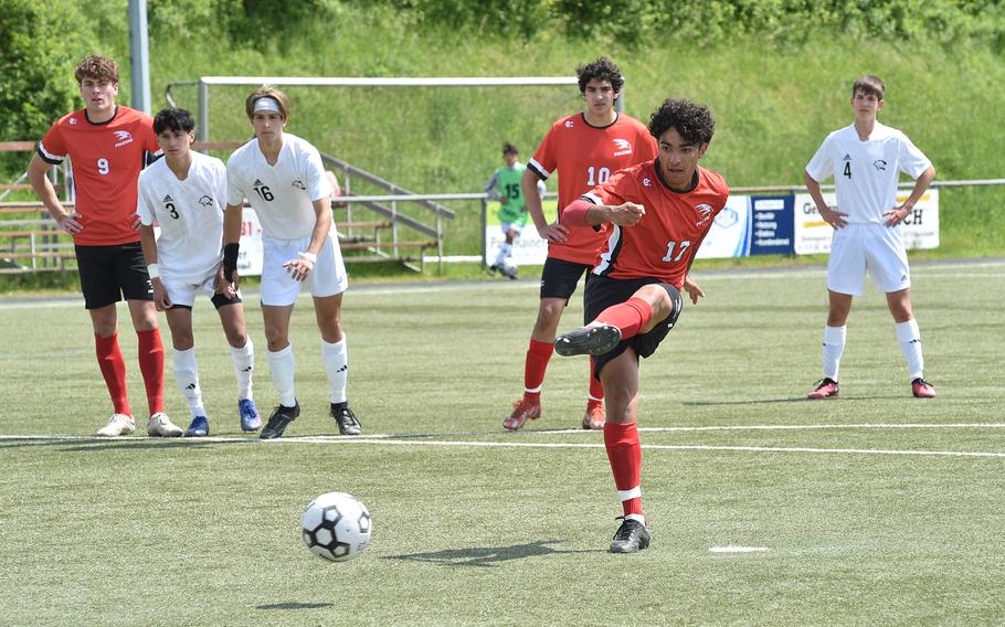 American Overseas School of Rome captain Nicolo Giuffrida shoots a penalty during a Division II semifinal against Vicenza at the DODEA European soccer championships on May 17, 2023, at VfR Baumholder's stadium in Baumholder, Germany.