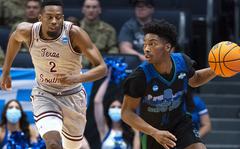 Texas A&M-Corpus Christis Terrion Murdix brings the ball downcourt, followed by Texas Southerns A.J. Lawson, at last year's NCAA mens basketball tournament in Dayton, Ohio, on March 15, 2022. The American Forces Network is adding four virtual channels to its app to livestream games during the annual NCAA tournament, which starts next week.