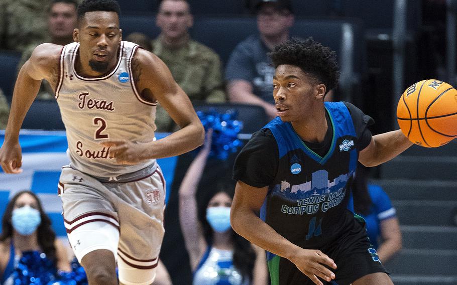 Texas A&M-Corpus Christi’s Terrion Murdix brings the ball downcourt, followed by Texas Southern’s A.J. Lawson, at last year’s NCAA men’s basketball tournament in Dayton, Ohio, on March 15, 2022. The American Forces Network is adding four virtual channels to its app to livestream games during the annual NCAA tournament, which starts next week.