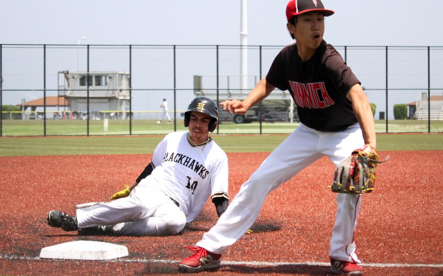 Kinnick's Kayden Tam takes the throw as Humphreys' Jaeton Abraham slides into third base.
