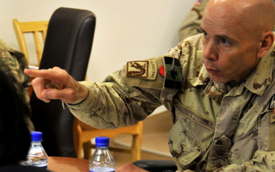 Then-Brig. Gen. Wayne Eyre, the Canadian army commander of NATO Training Mission-Afghanistan, talks with Afghan army and police leaders in 2014. Now a lieutenant general and the acting head of Canada’s armed forces, Eyre wrote a public letter acknowledging questions about the legacy of their time in Afghanistan, after the Taliban took control of Panjwai district in southern Kandahar province, where many Canadians fought and died.